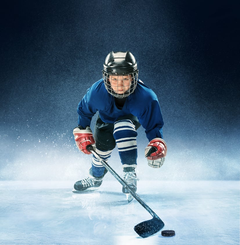 Little boy playing ice hockey